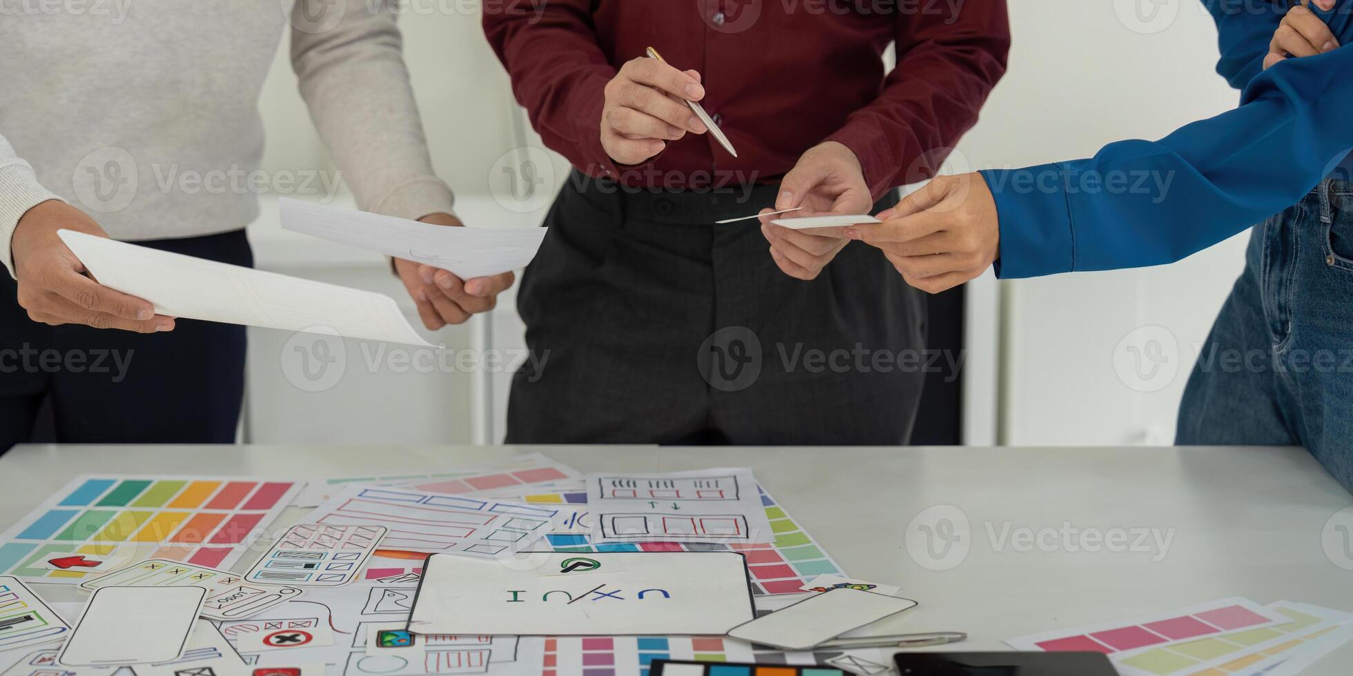 Idea Development and UX Strategies. Team exploring ideas for user experience strategies with sketches and digital tools. photo