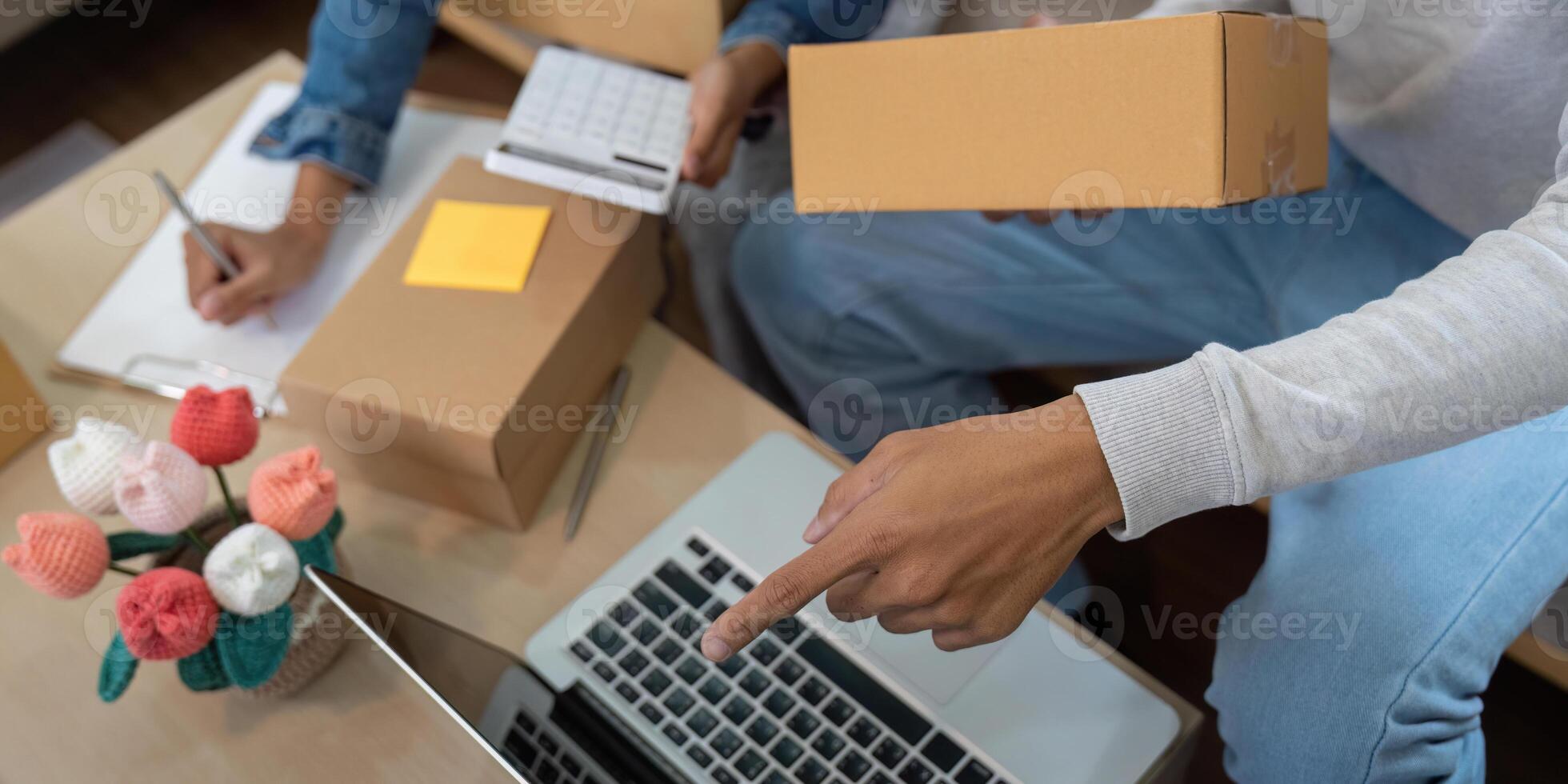Order Fulfillment and Shipping. A couple efficiently preparing packages for their online business. photo
