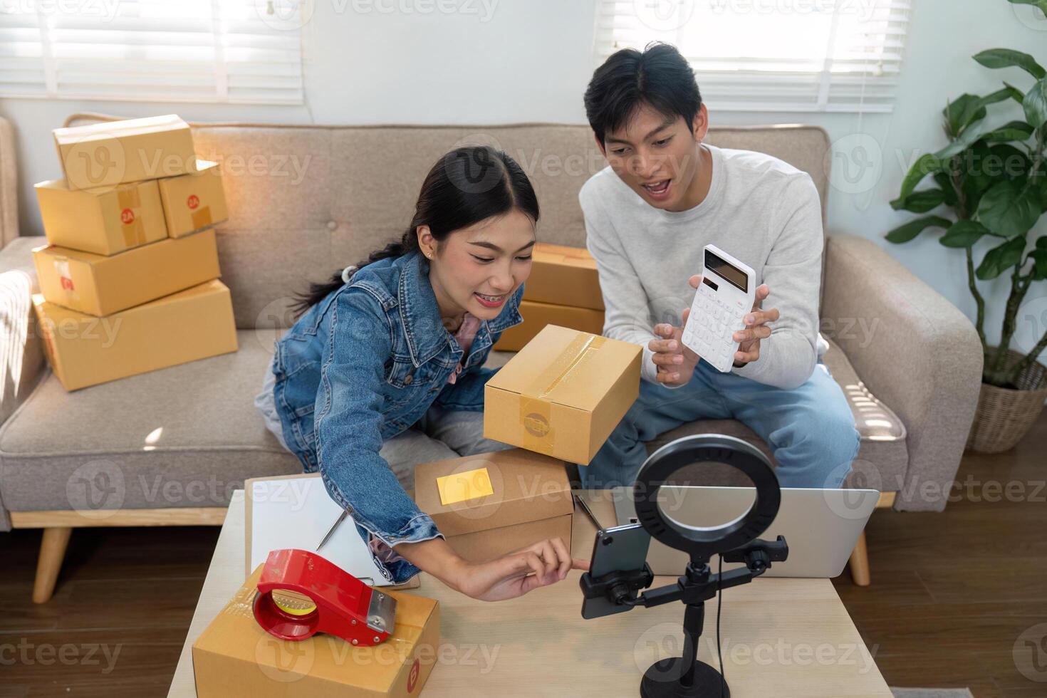 Entrepreneurship and E-commerce. A young couple managing their online business by packing and organizing products. photo