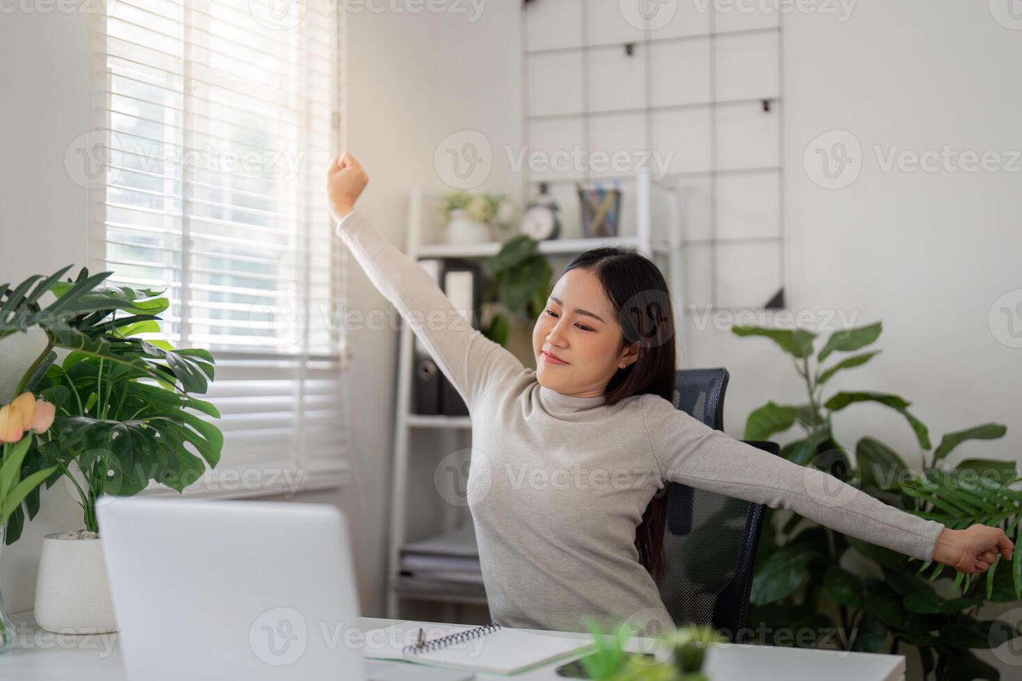 Break and Refresh. A woman enjoying a moment of relaxation during her work-from-home routine. photo