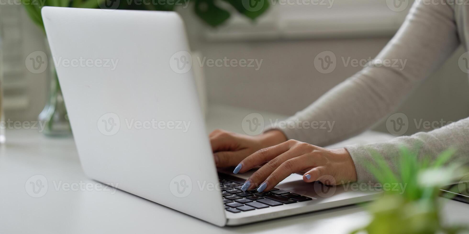 Remote Work and Productivity. A person working from home on a laptop while focusing on tasks. photo