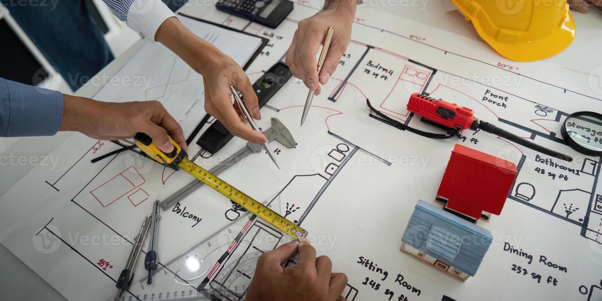 Architecture and Collaboration. Construction team analyzing design blueprints and planning measurements for a building project. photo