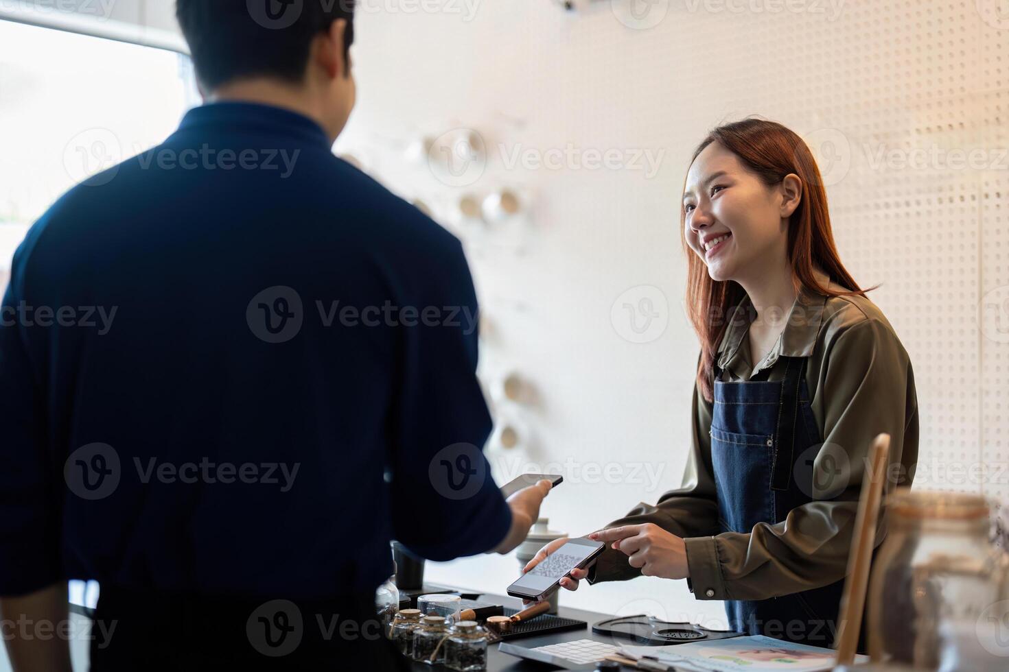 Sustainable Practices and Customer Engagement. A barista sharing eco-friendly options with a customer at the cafe. photo