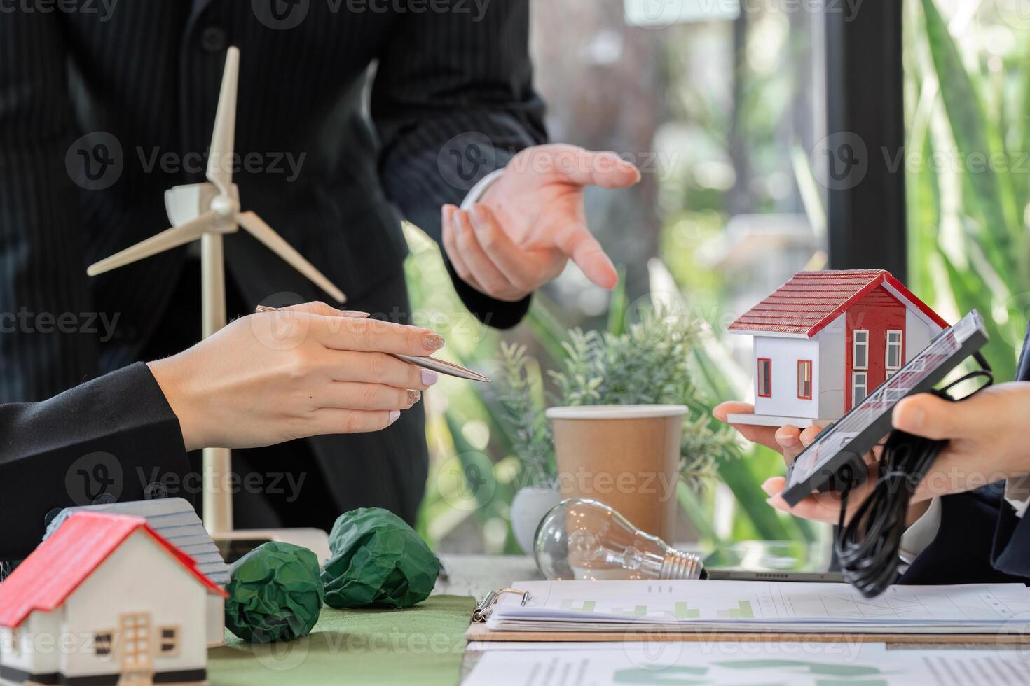 Collaboration and Sustainable Energy. A professional team discusses model projects with a focus on solar energy. photo