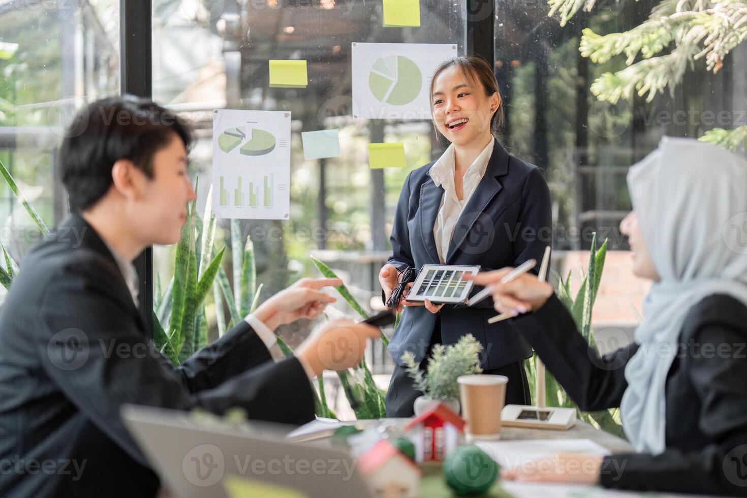 Sustainable Practices and Team Collaboration. A diverse team discussing eco-friendly projects in a modern office setting. photo