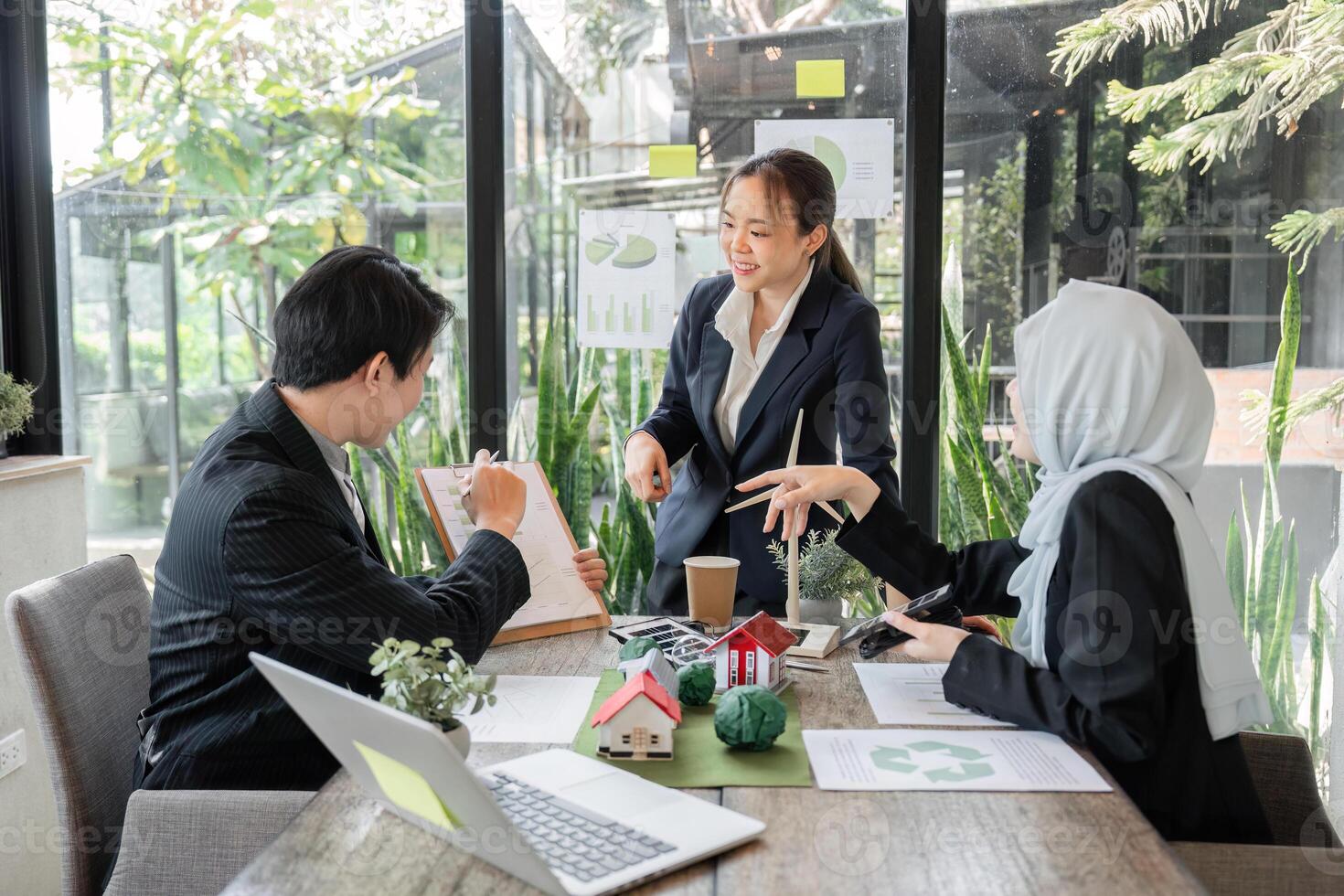 Collaborative Strategies and Eco-design. Professionals brainstorming sustainable approaches in a modern workplace. photo
