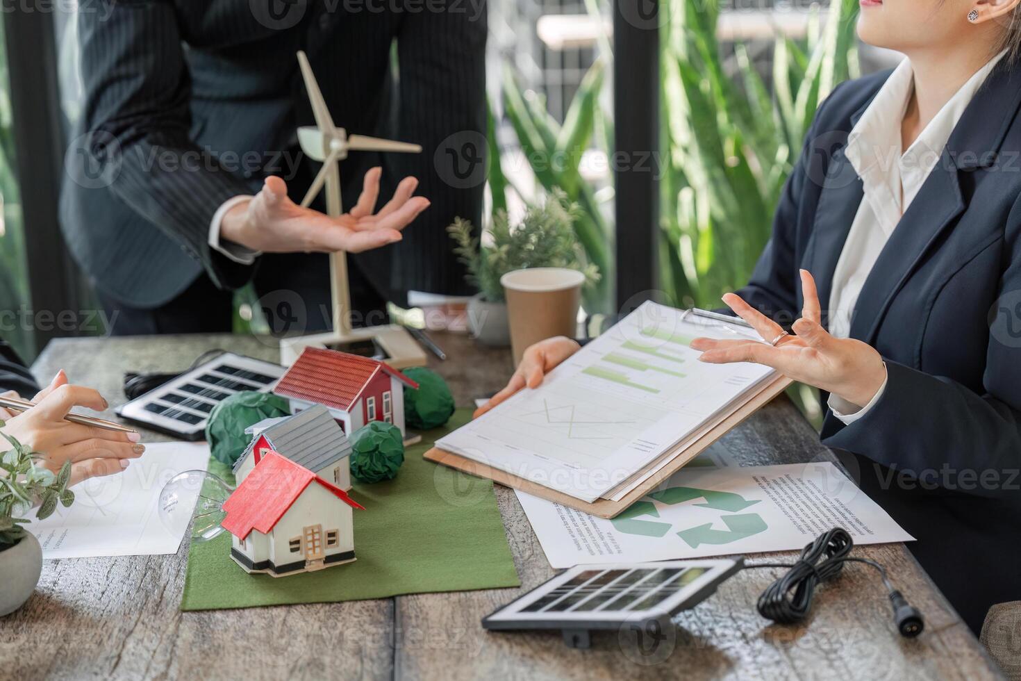 Sustainable Development and Environmental Planning. A meeting focused on eco-friendly housing solutions using scale models. photo