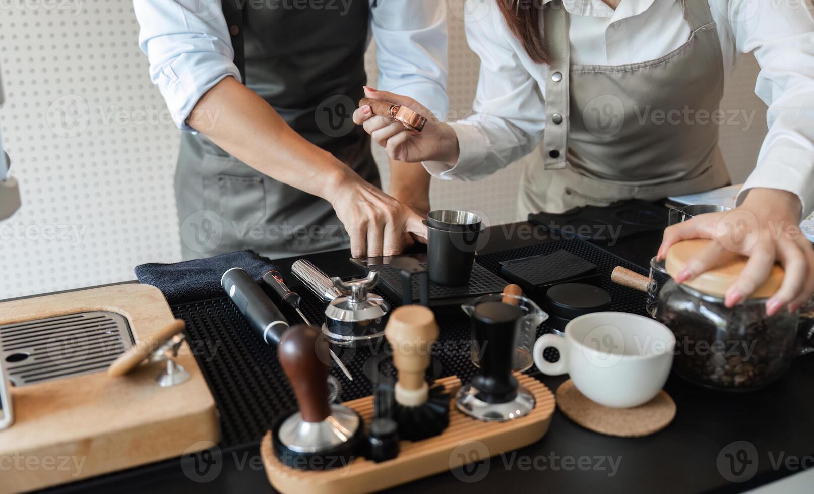 Coffee Preparation and Artisan Skills. Baristas collaboratively showcasing their skills in brewing and serving coffee. photo