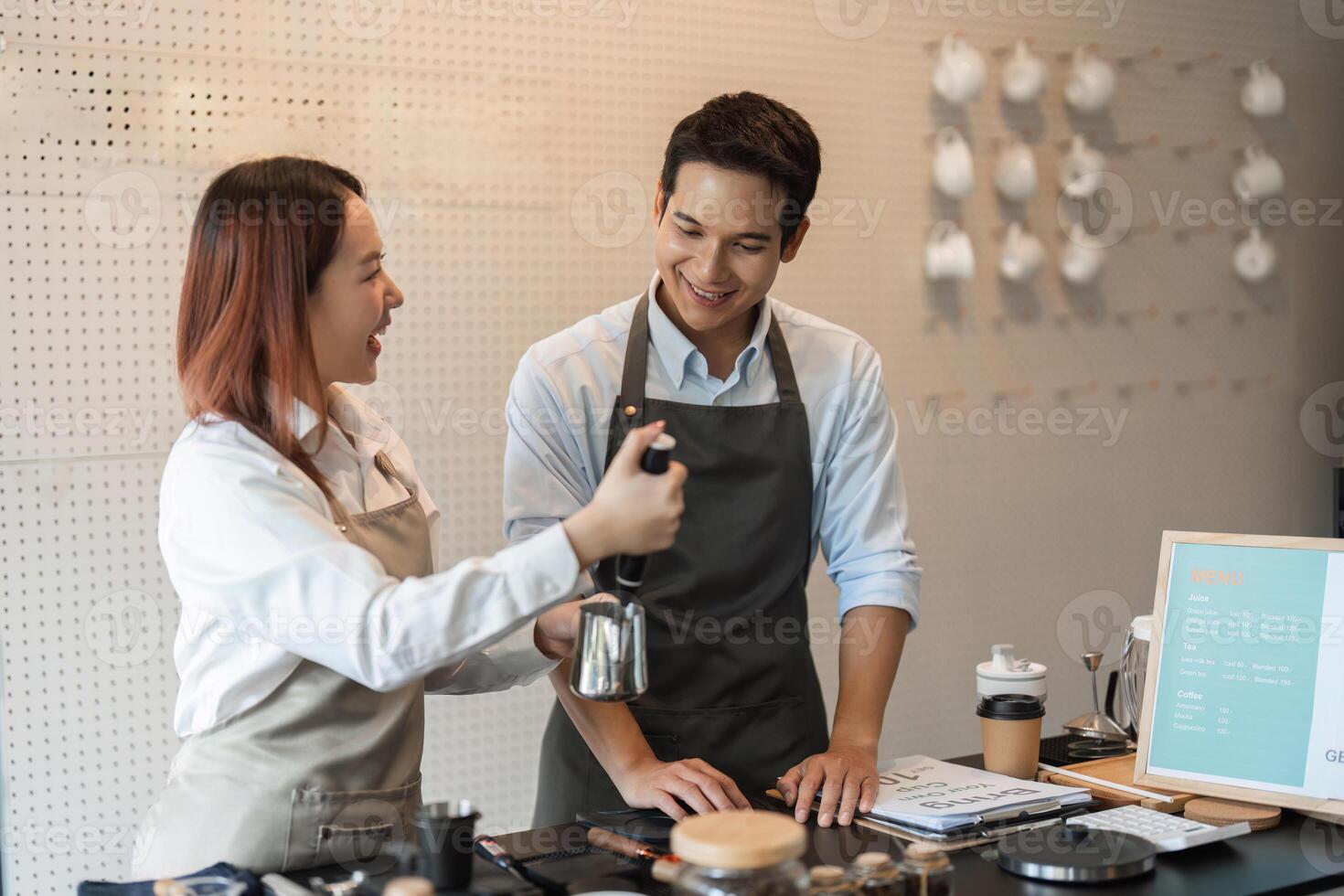 Teamwork and Coffee Brewing Skills. Two baristas enthusiastically collaborating in the cafe, sharing knowledge and brewing techniques for a delicious coffee experience. photo