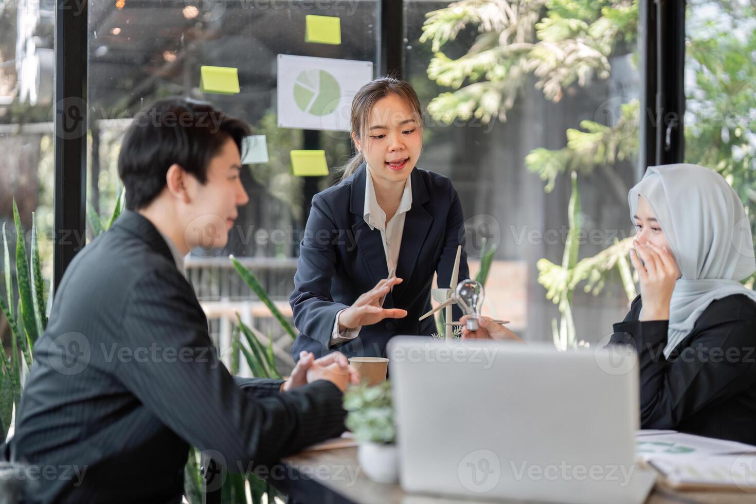 Sustainable Business Planning. A diverse team discussing renewable solutions in a bright, inspirational workspace. photo