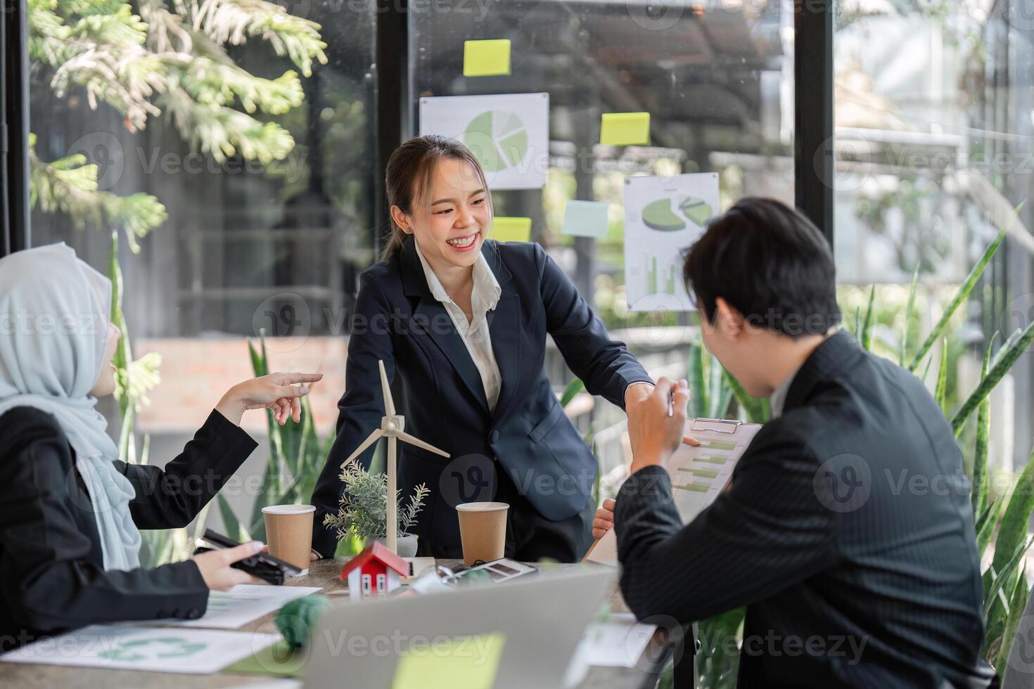 Sustainability and Team Collaboration. A professional team engages in a discussion about sustainable practices in an eco-friendly workspace. photo