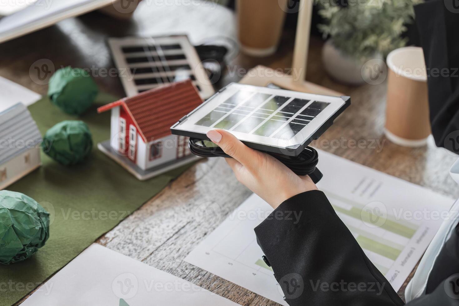 Sustainable Development and Solar Technology. A team reviewing solar technology for improving energy efficiency in homes. photo