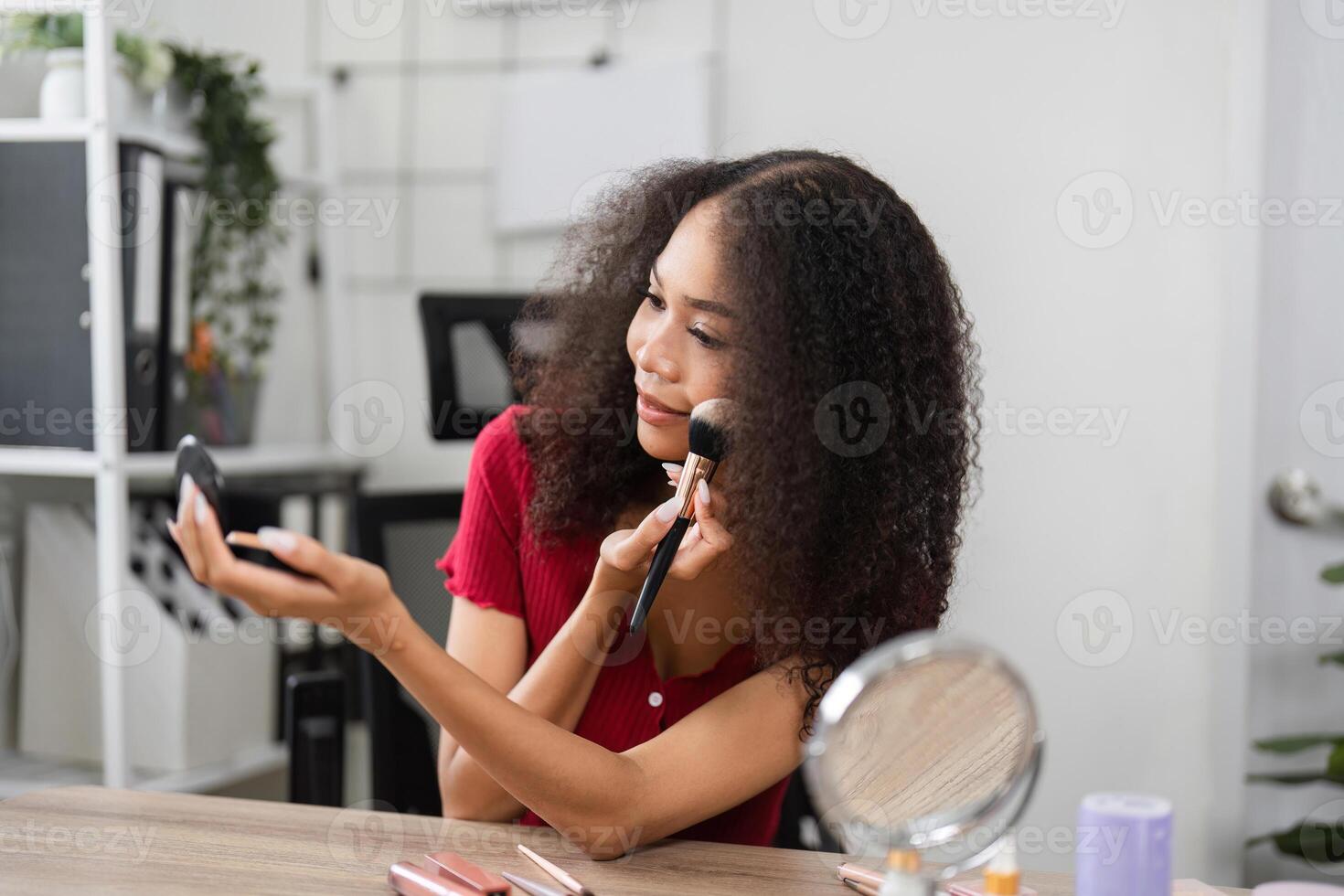 Radiant Skin and Makeup Application. A woman enjoying her makeup application while smiling and expressing her personality and joy. photo