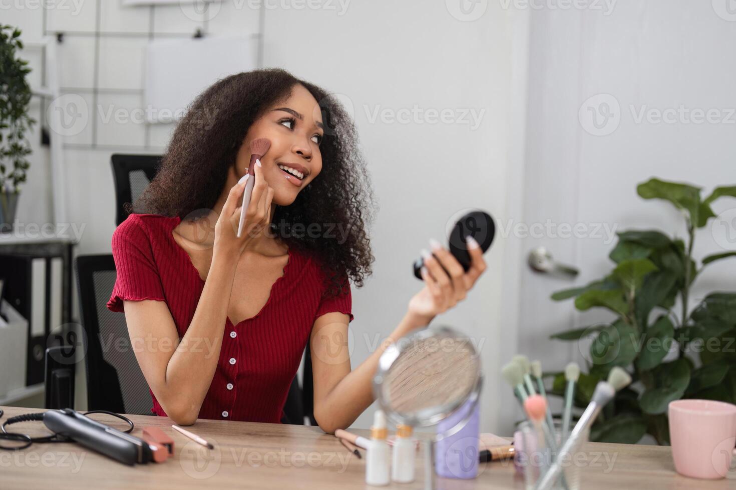Natural Beauty and Skin Positivity. A joyful woman enjoying her makeup routine in a charming space. photo