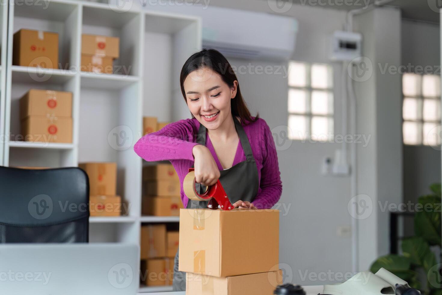 Efficient Order Preparation and Management. An engaged woman packaging products in her workspace, emphasizing the importance of streamlined processes in online sales. photo
