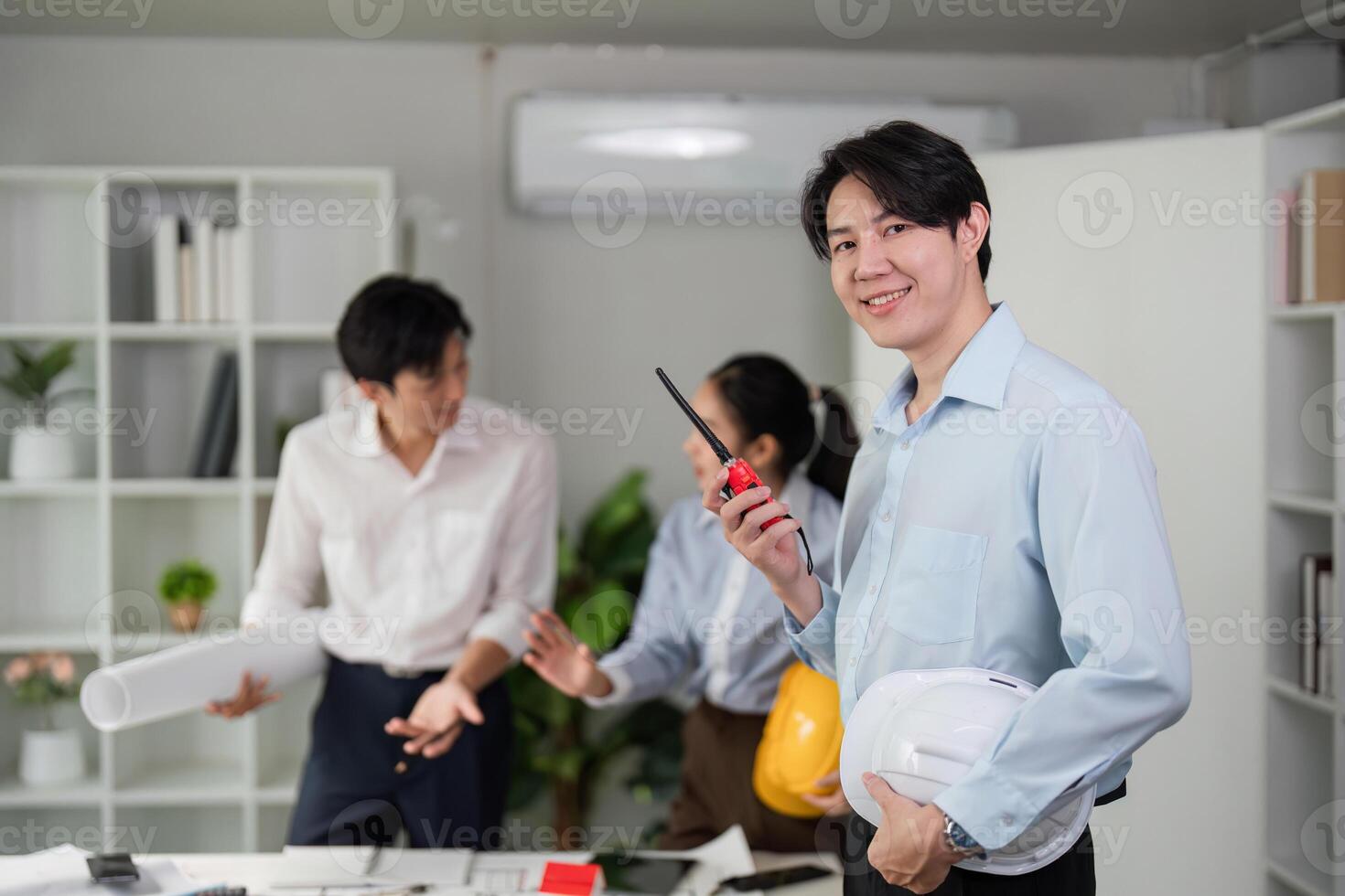 Collaboration Tools and Workplace Strategy. A team assessing construction plans with high-tech equipment in a vibrant office. photo