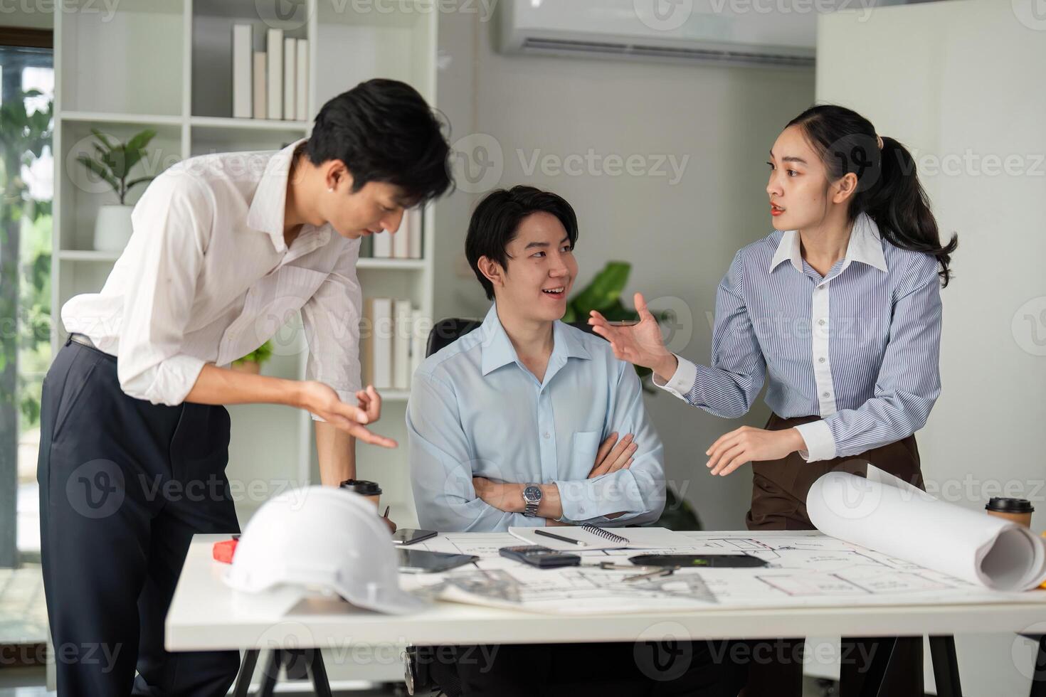 Team Dynamics and Idea Sharing. Professionals engaged in a lively discussion about building plans. photo