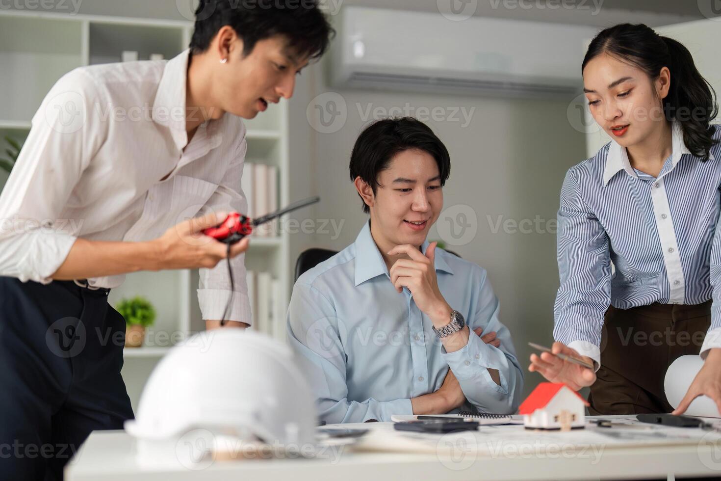 Collaboration and Project Planning. A team of professionals strategizing over architectural designs. photo