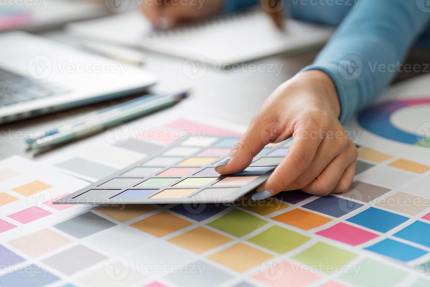 Palette Planning and Creative Process. A designer analyzing color options and textures. photo