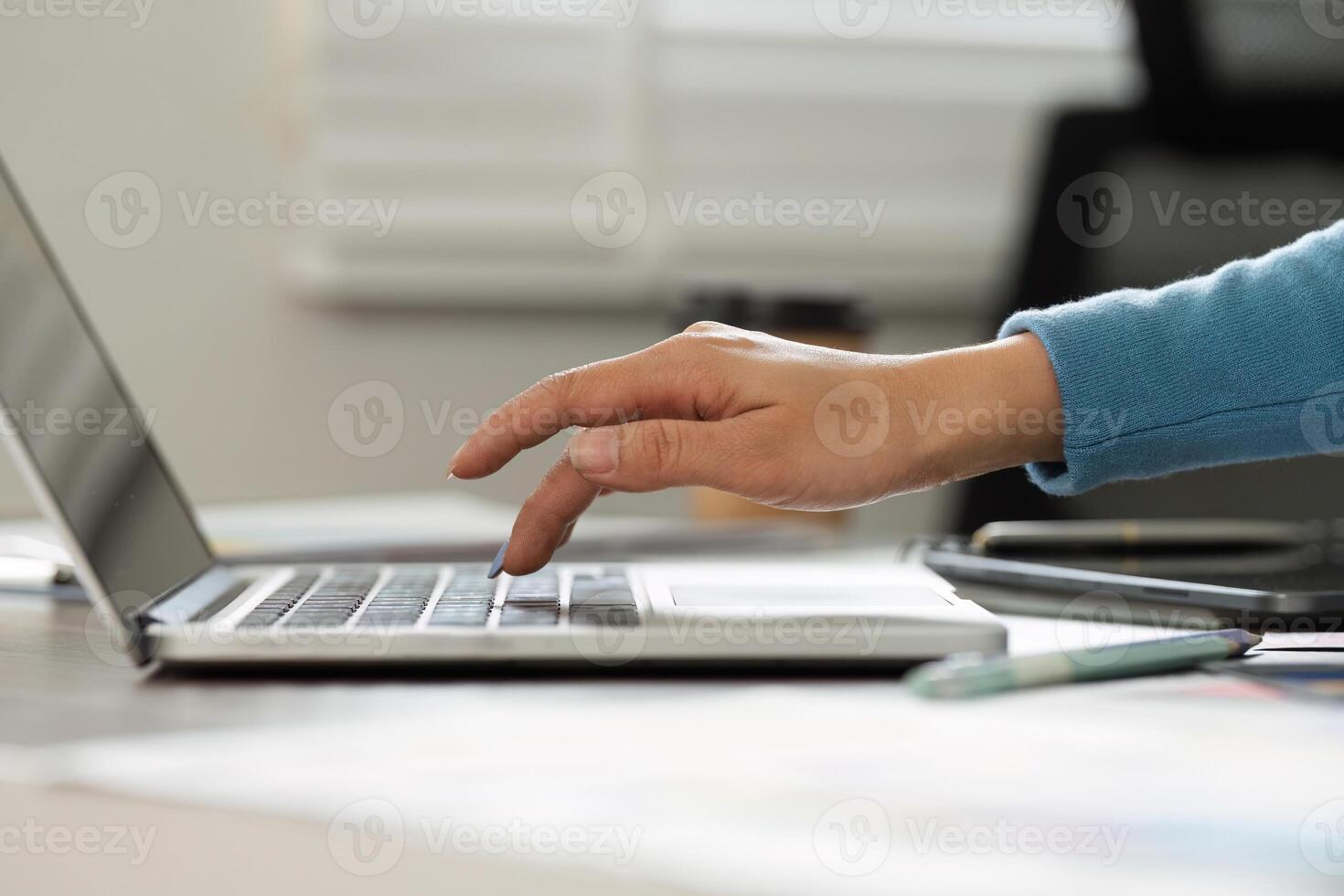 Focus and Productivity. A close-up of hands typing on a laptop, capturing the essence of creativity and concentration in the design field. photo