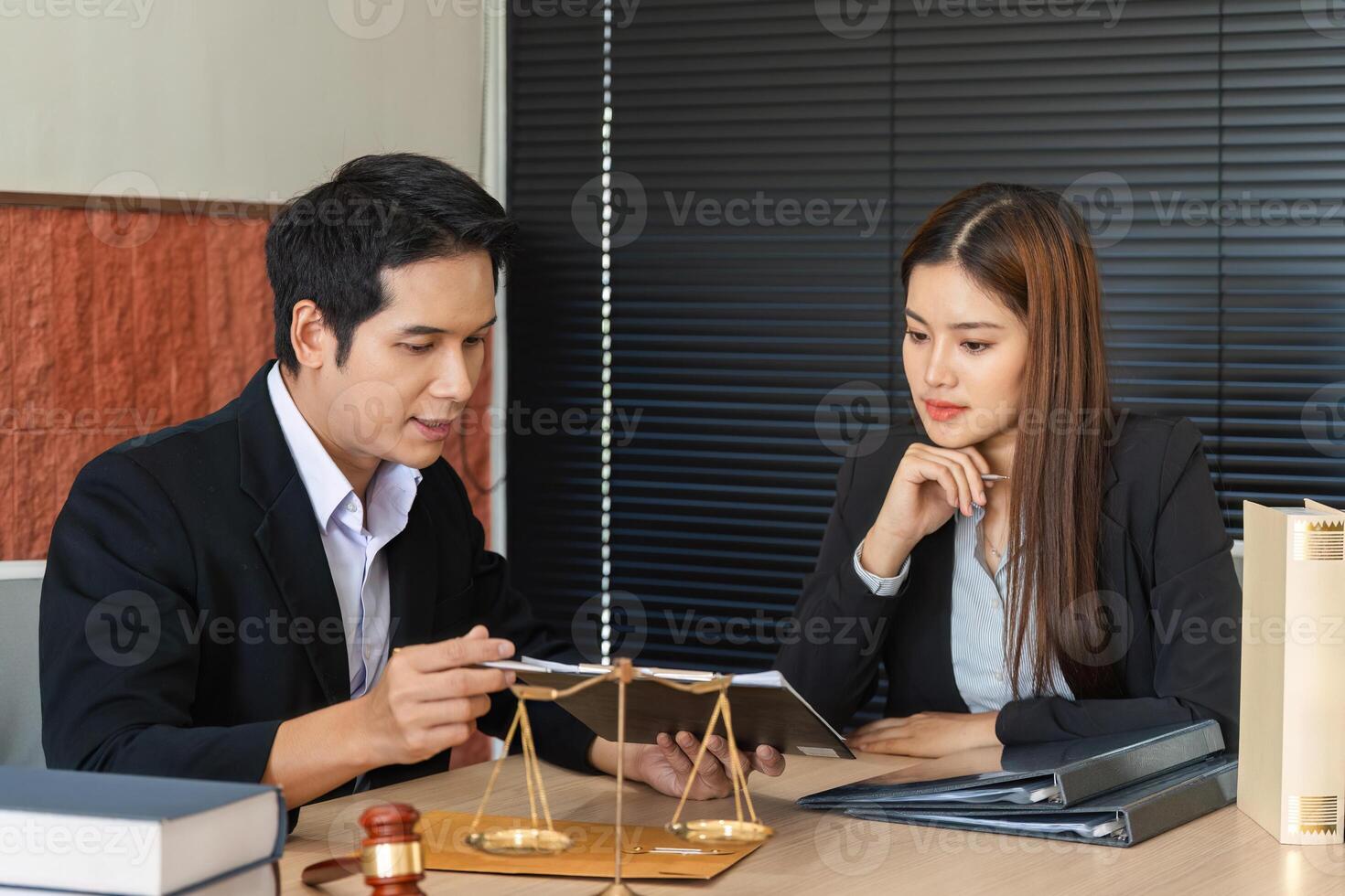 Lawyering and Client Communication. A lawyer guiding a client through legal options using a tablet. photo
