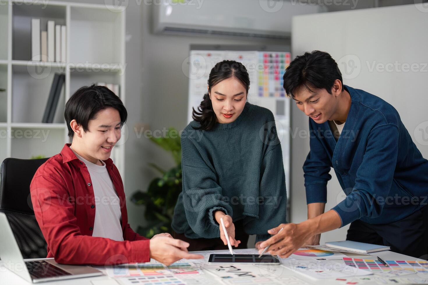 Team Dynamics and Design Collaboration. Team members reviewing color palettes and mockups for an innovative project. photo