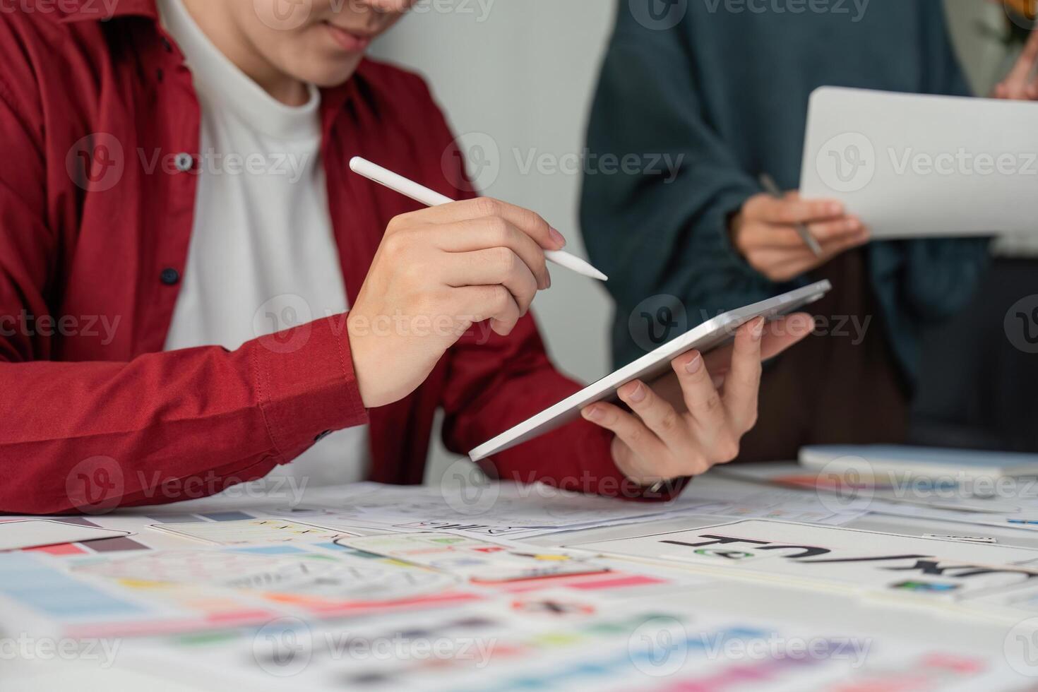 UIUX Development and Digital Tools. Designer focusing on a digital interface while collaborating on a complex project. photo