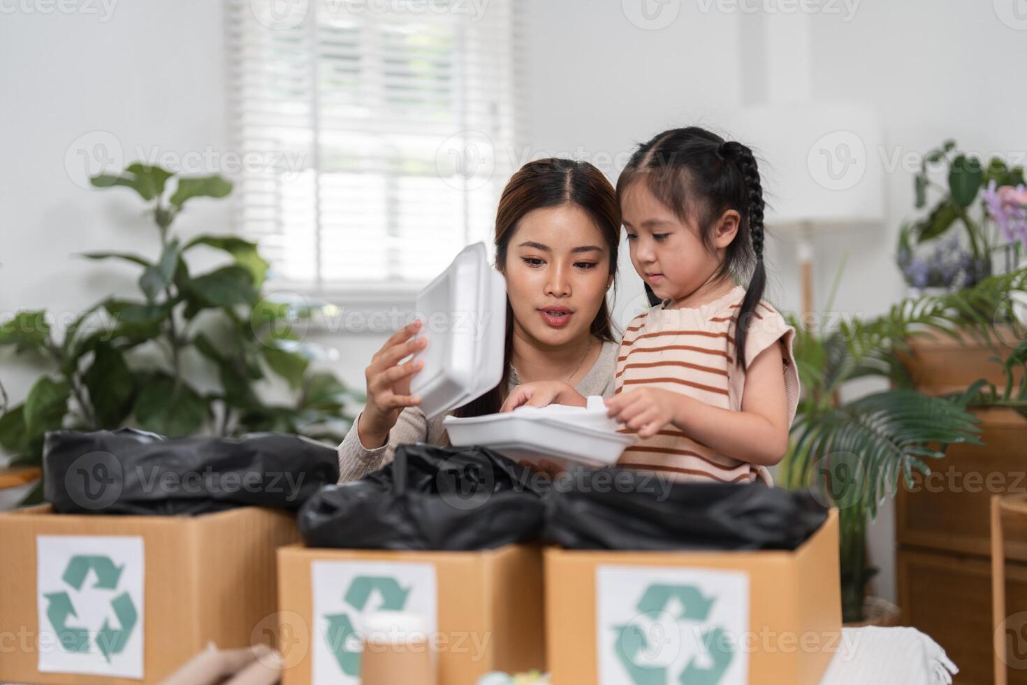 Environmental Awareness and Educational Moments. A mother and daughter engage in recycling while discovering the importance of responsible disposal. photo