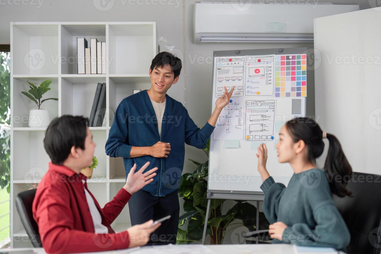 Interactive UI Presentation. A presenter engages the team while showcasing design layouts and features. photo