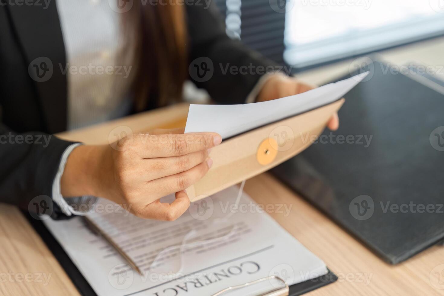 Legal Workflow and Document Handling. A professional organizing contract paperwork efficiently. photo