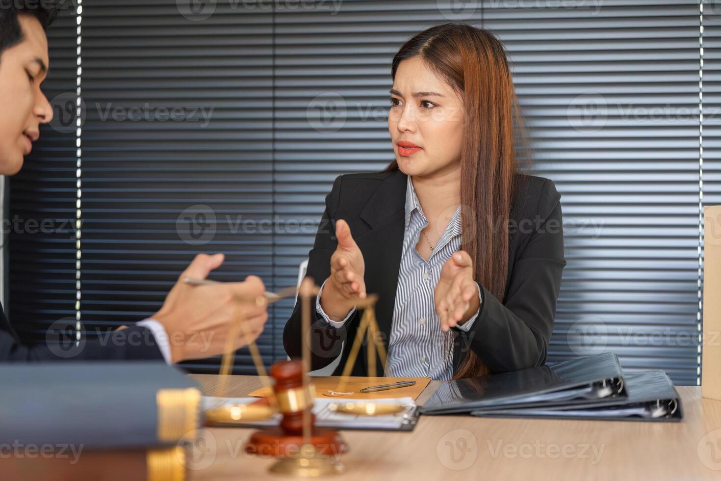Client Consultation and Legal Strategy. A serious discussion between a lawyer and client about case details. photo