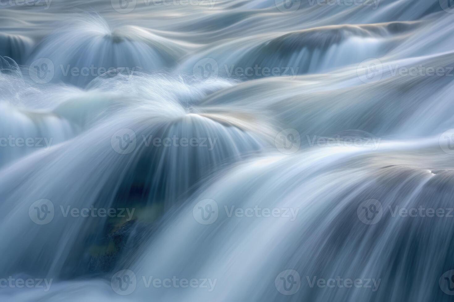 Flowing water cascades gently over smooth rocks in a tranquil river setting photo