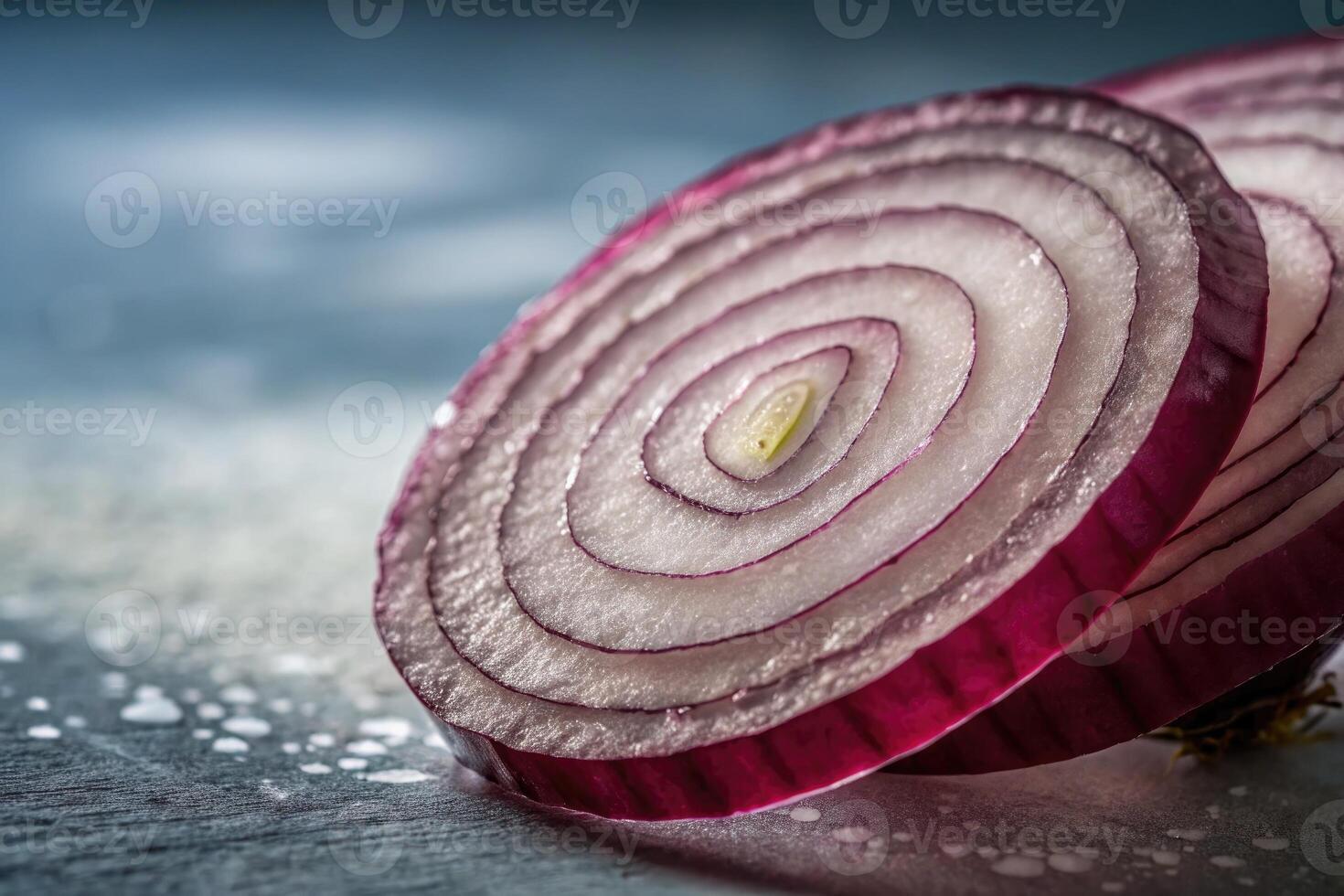 Slices of red onion displayed on a textured surface in natural light during midday photo