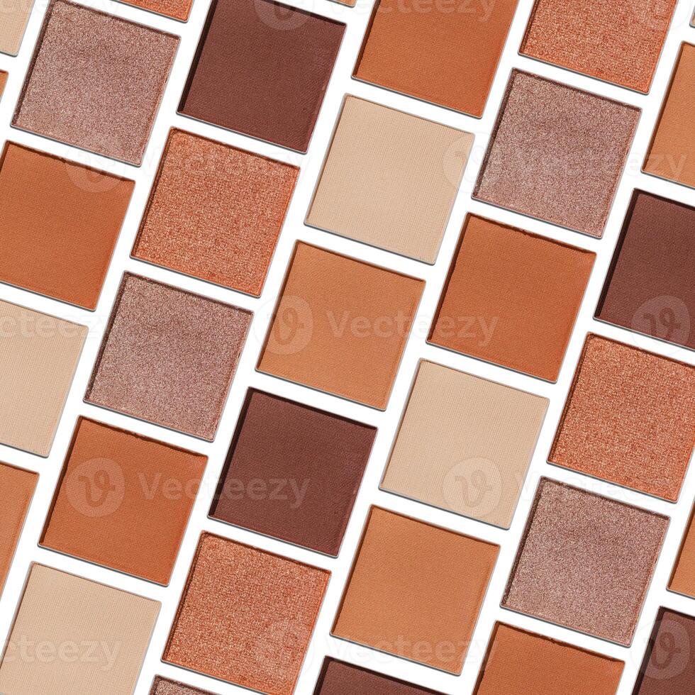 Eyeshadow palette, mix of matte and shimmer shades in brown, nude, orange hues. Aesthetic top view pattern for beauty, makeup, cosmetics themes, Neutral colored swatches eyeshade refills photo