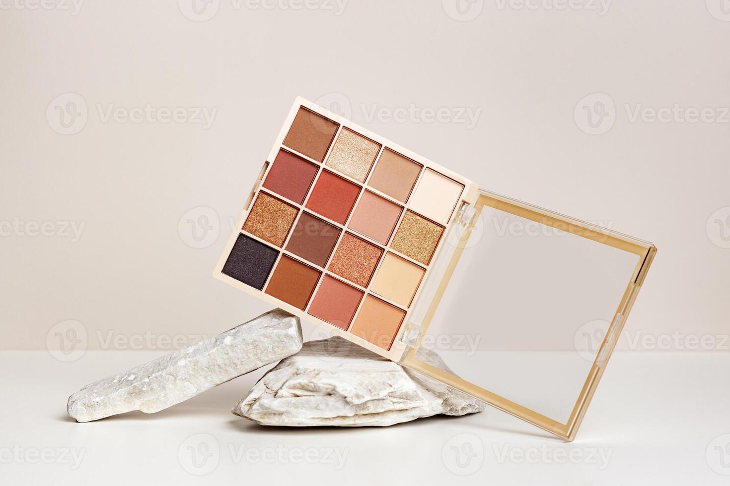 Eyeshadows palette mockup on stand from natural stone. Beauty product cosmetic powder for make up eye, beige brown color scheme, matte and shimmer tints. Cosmetic product minimal style. photo