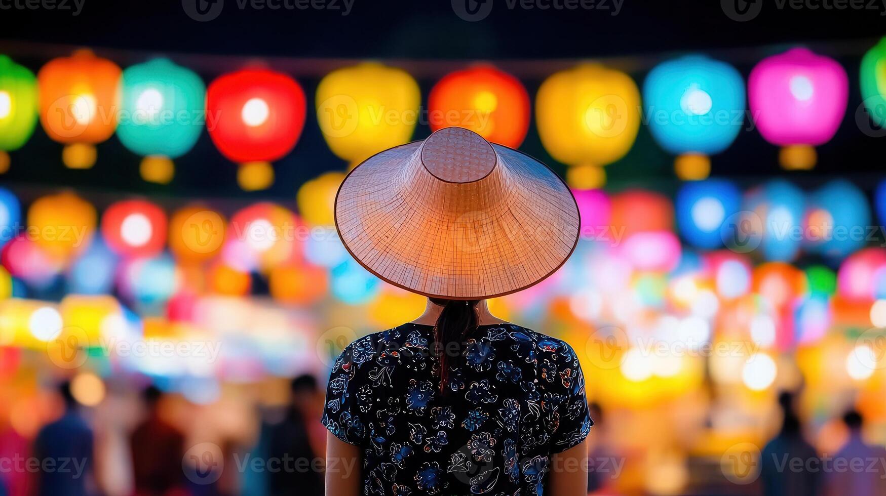 Woman in Traditional Asian Hat Admiring Colorful Lantern Festival Lights at Night photo