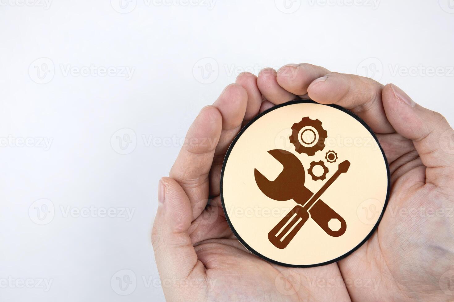 Hand holding paper with gear icon and mechanic tools. Concept of maintenance, process of maintaining and repairing equipment or systems to work efficiently. photo