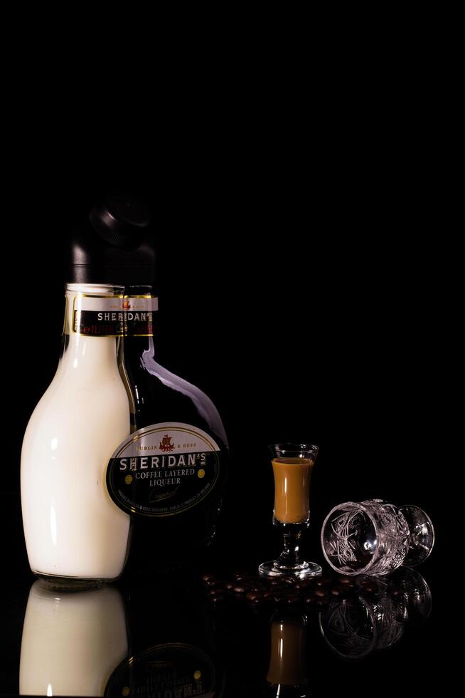 A bottle of milk and a glass of coffee photo