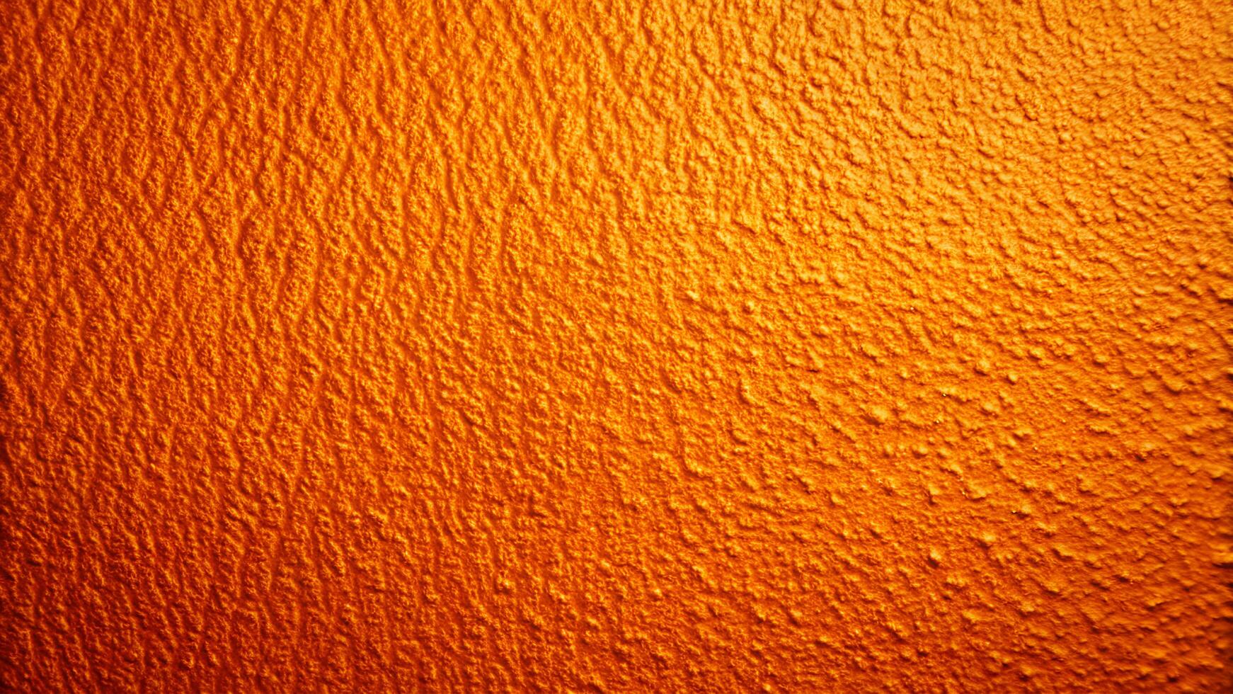 Textured Orange Surface with Rich Color and Detailed Bumps photo