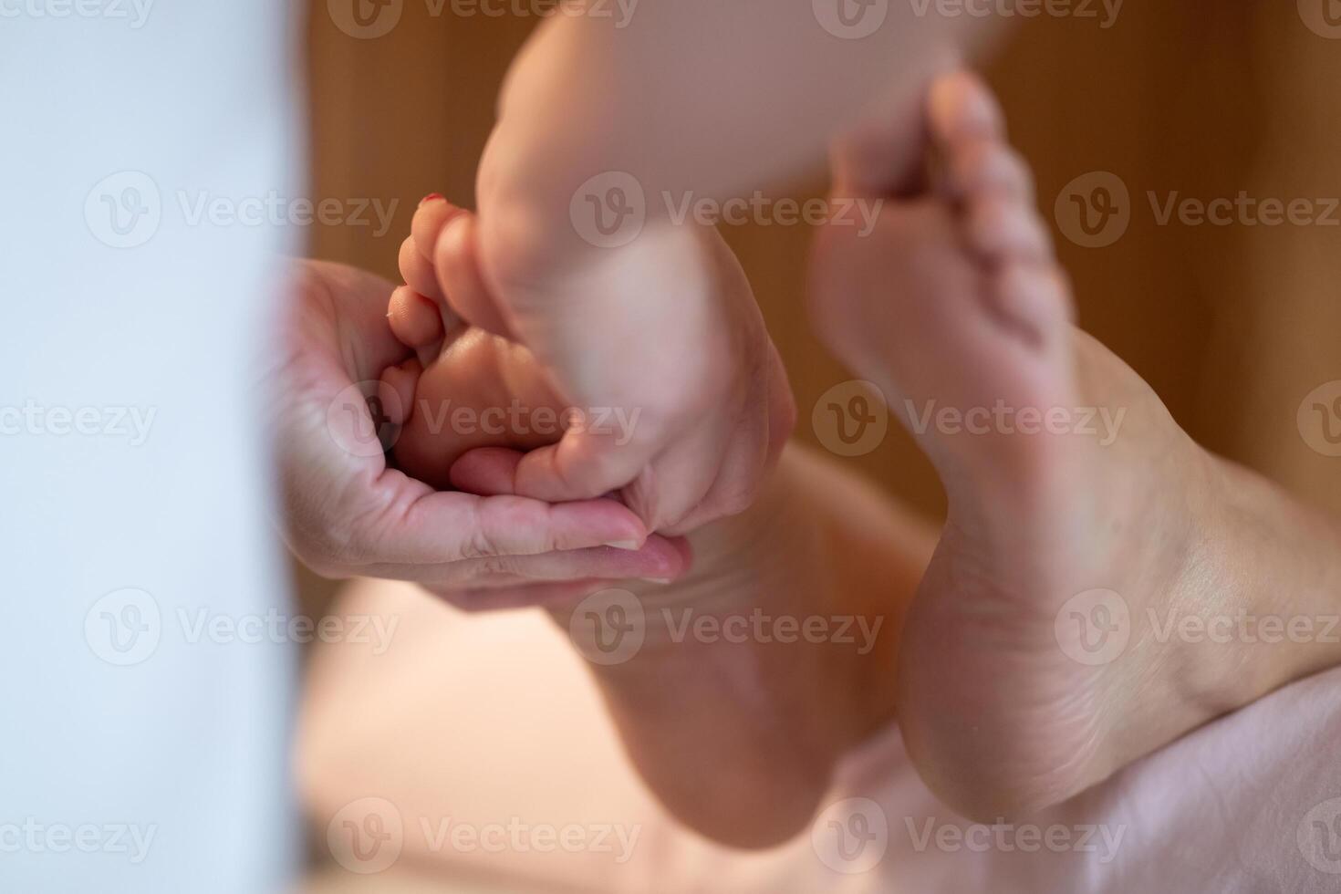 Foot Massage Therapy in a Relaxing Spa Setting. A professional massage therapist in a white uniform provides a soothing foot massage to a client in a calm and serene spa environment photo