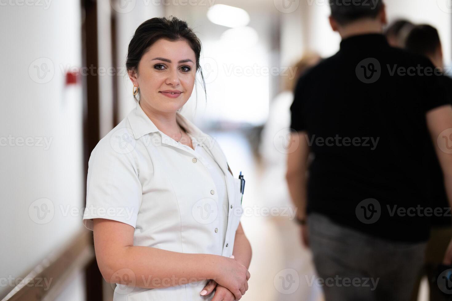 A tired nurse takes a quiet moment to rest in the hospital hallway, reflecting on a long and demanding shift. photo
