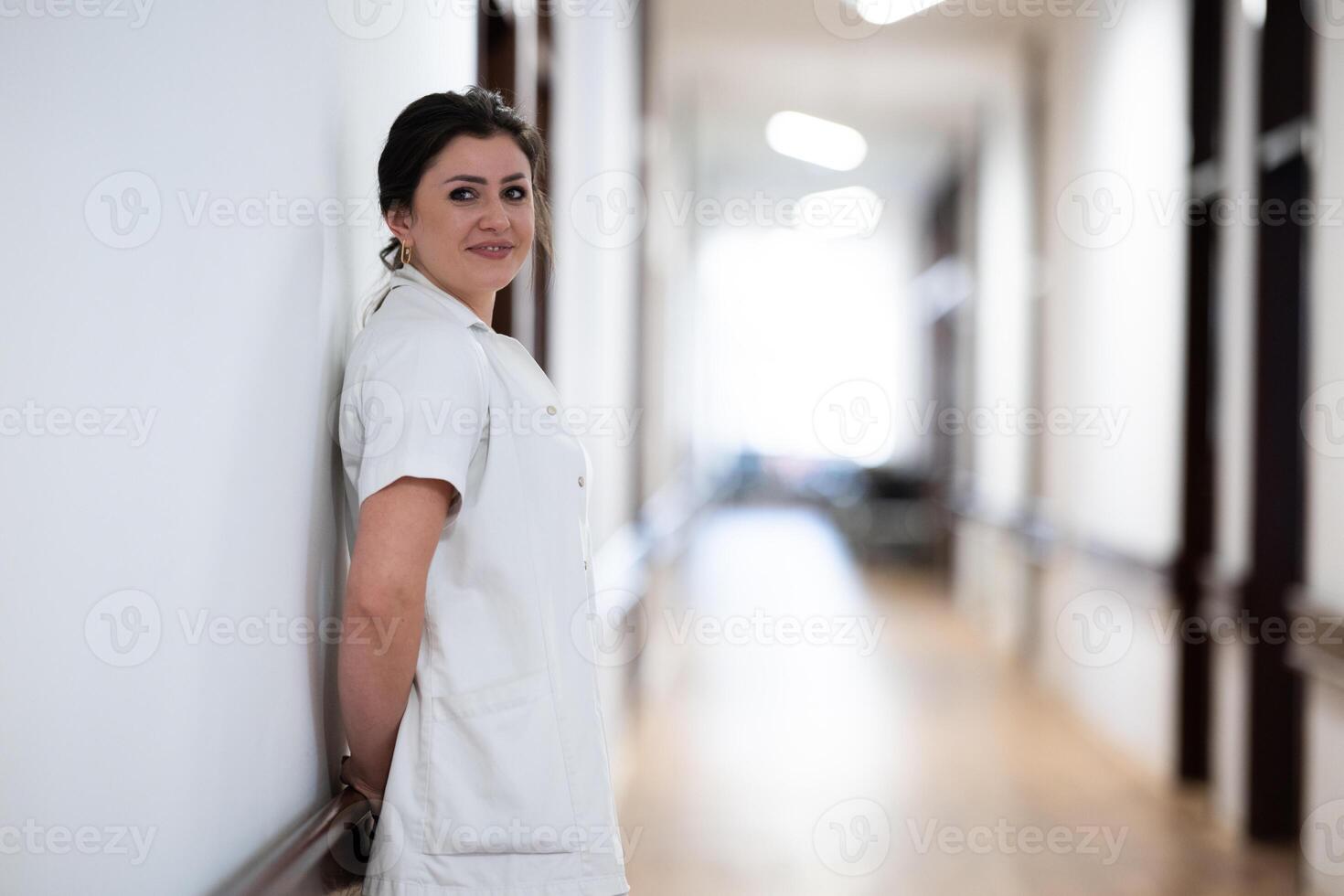 A tired nurse takes a quiet moment to rest in the hospital hallway, reflecting on a long and demanding shift. photo