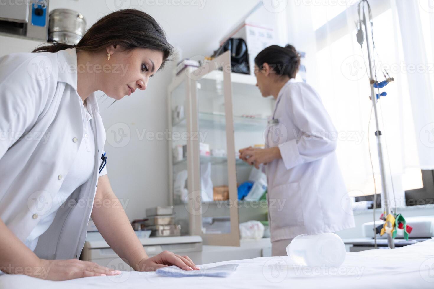Two nurses in a hospital laboratory are carefully inspecting and preparing medications for patients and hospital use. photo