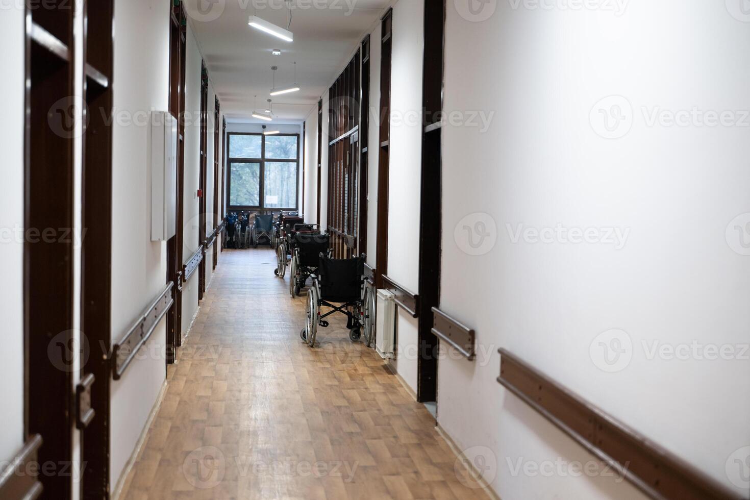 A row of wheelchairs neatly lined up in a hospital corridor, ready for patients in need of mobility assistance photo