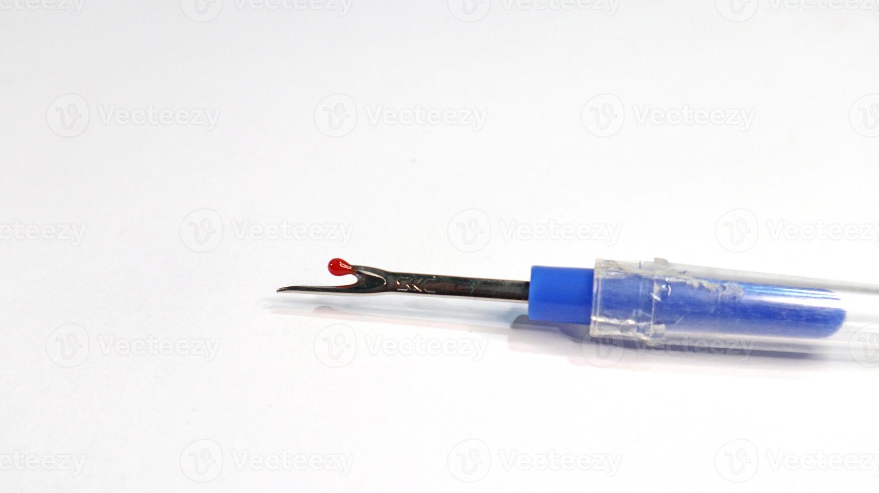 Isolated sewing seam ripper on white background photo