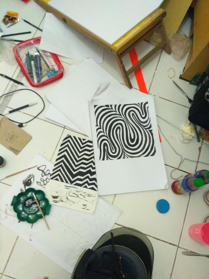 a table with various items on it, including a drawing photo