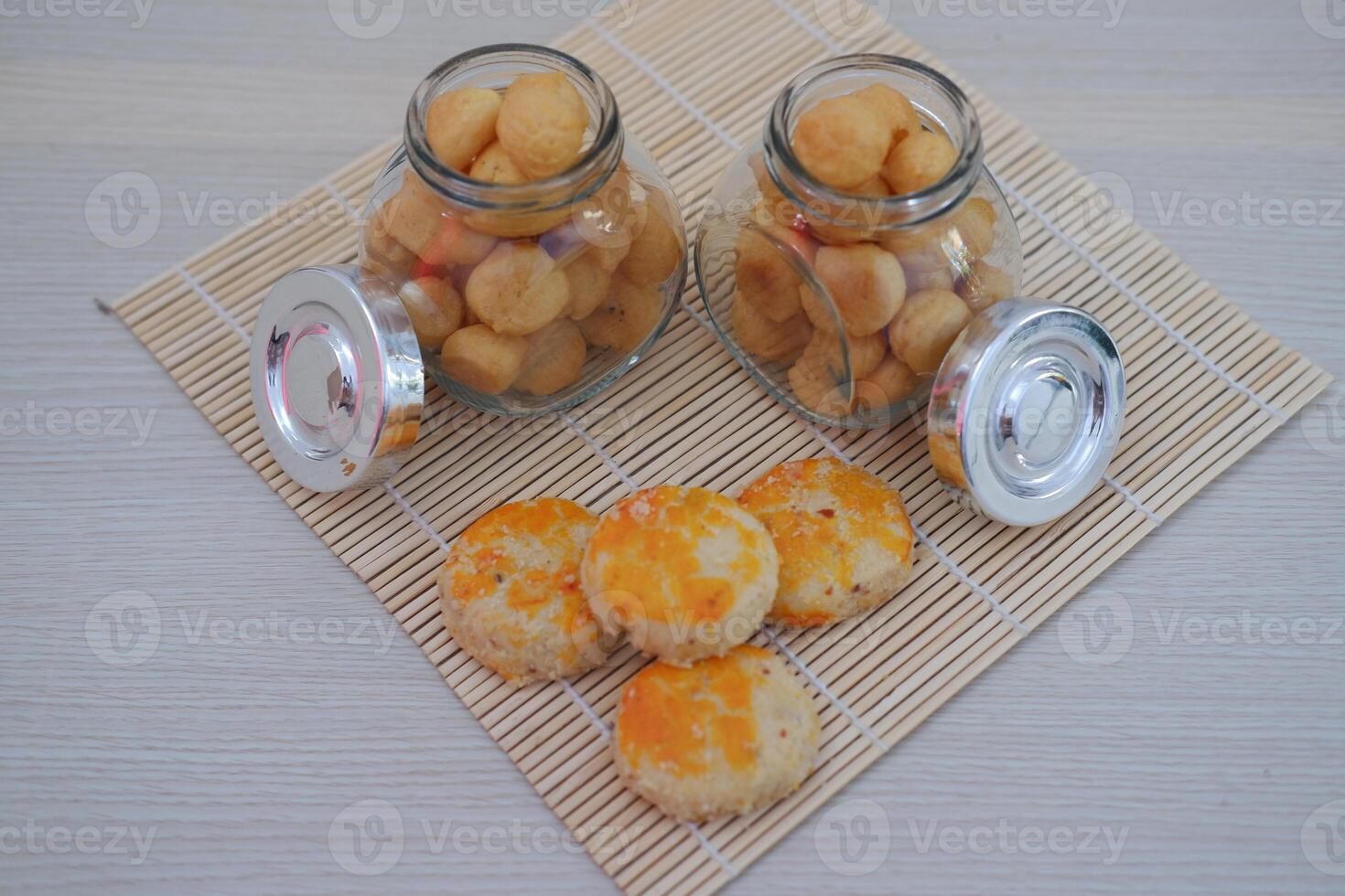 two small glass jars filled with golden brown bite sized cookies photo