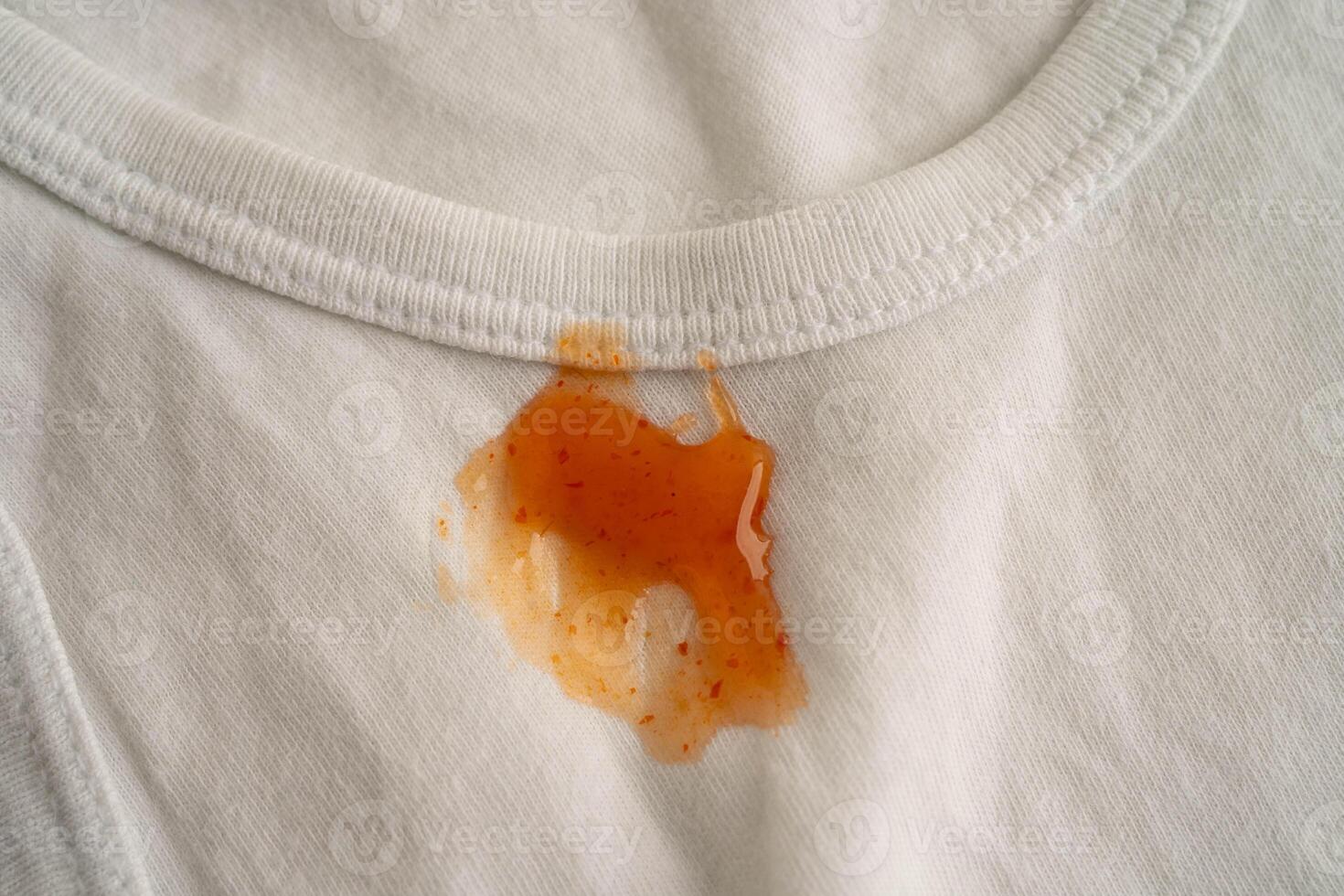 Dirty tomato sauce stain removal or ketchup on cloth accident to wash with washing powder, cleaning housework. photo