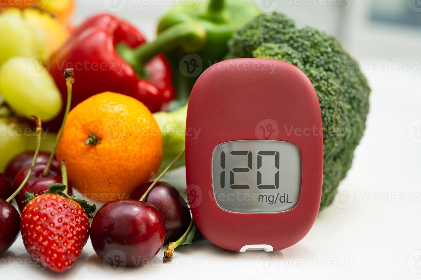 Glucose meter with vegetable and fruit for check sample blood sugar level to treatment di photo