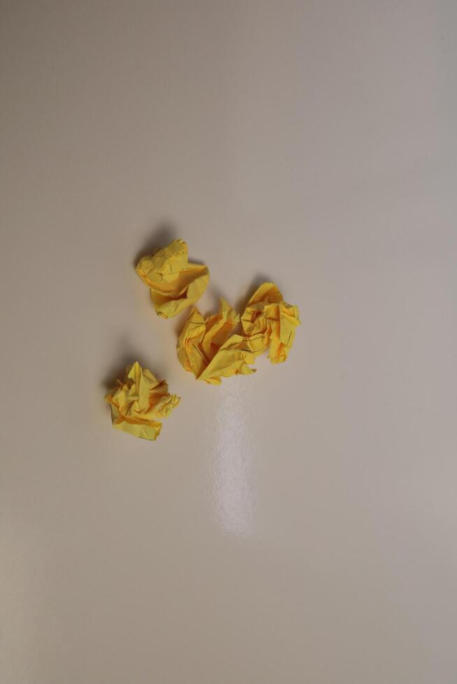 Yellow scraps of paper are thrown on a white background. photo